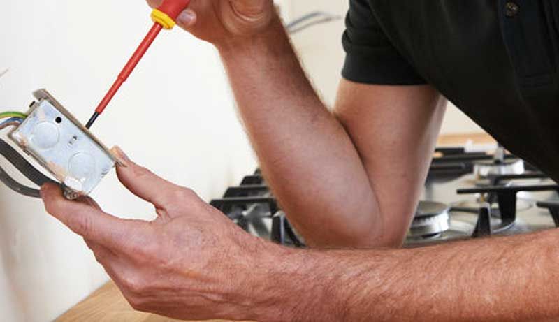 Electrician checking power outlet